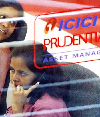 An employee of life insurance company, ICICI Prudential, speaks on a phone in Mumbai.