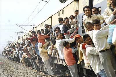 Passengers travel in an over-crowded train.