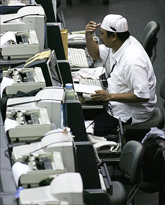 A broker speaks on the phone during a trading session at the Indonesia Stock Exchange.