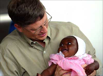 Bill Gates holds baby girl Cecil Massango during his visit to a health centre in Mozambique.