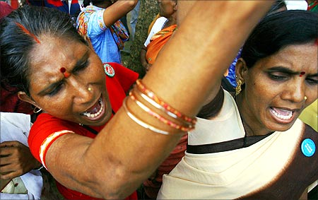 Women shout slogans during a demonstration by people displaced by proposed SEZ near Mumbai.
