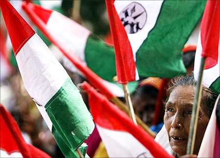 A woman holds a flag during a demonstration against SEZ in Maharashtra.