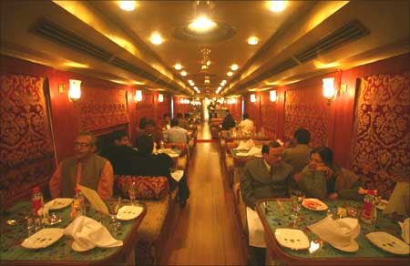 Guests have their dinner at the 'Swarna Mahal' dining coach of the luxury train 'Royal Rajasthan'