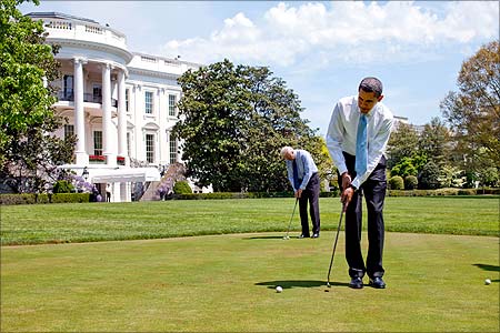 US President Barack Obama and Vice President Joe Biden practice their putting on the White House putting green.