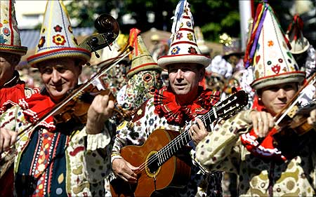 People dressed as Flinserl participate in a parade during the daffodil festival in the Austrian village of Bad Aussee.