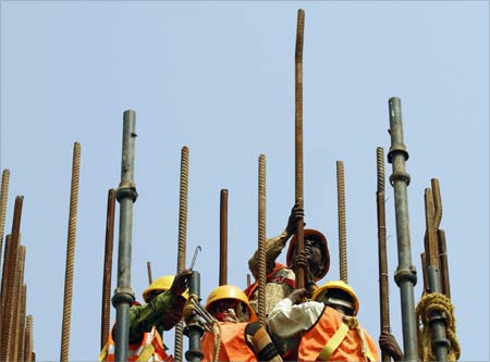 Labourer work at a construction site of a flyover in New Delhi.