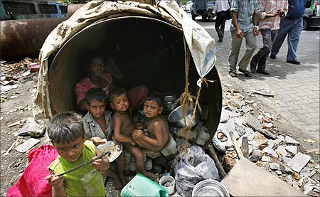 Children eat in their his make-shift home in an unused waterpipe in Mumbai.