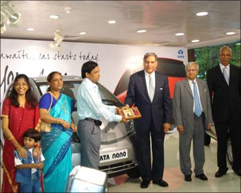 Ashok Vichare, the first owner of  Tata Nano gets keys from Tata Group chairman Ratan N Tata.