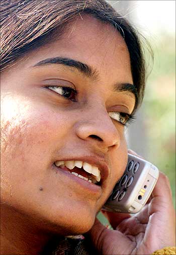 A woman uses a cell phone.