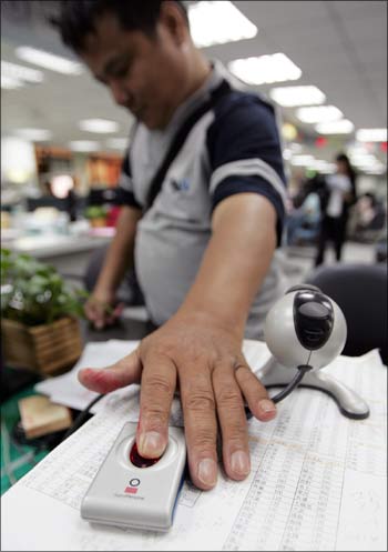 A man has his fingerprint scanned at a household registration office in Taipei to build a national fingerprint database by joining a global trend for biometric identity cards.