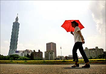 A woman walks past the Taipei 101 building in Taipei.