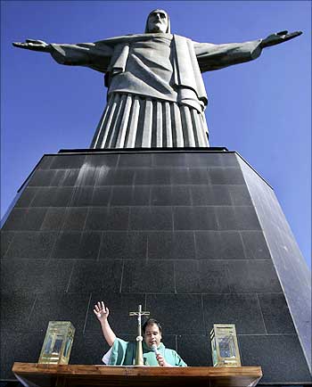 A priest holds a mass at the base of the Christ the Redeemer statue in Rio de Janeiro.