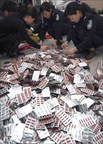 Policemen check confiscated fake drugs in Xuchang in China.