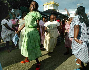 A woman dances to celebrate the founding of the tiny port town of Livingston, Gautemala