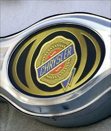 A Chrysler logo is seen atop a New York City car dealership.