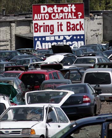 A large 'Buy American' sign, in support of Detroit's auto industry, is seen in the back of an auto scrap yard in Detroit, Michigan.