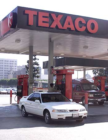 Oil giant Texaco rounds off the list at No 10. Seen here, a customer buys gasoline at a Texaco gas station in Los Angeles October 16, 2000.