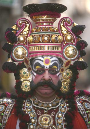 An artist from Karnataka takes part in a religious procession.