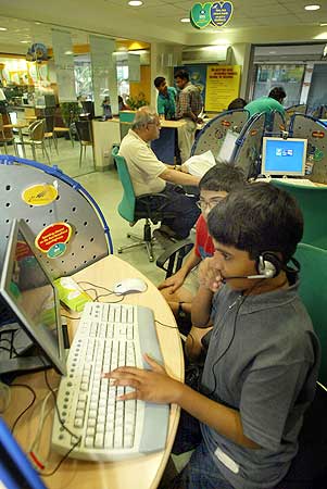 Children play computer games at a high-speed broadband internet cafe.