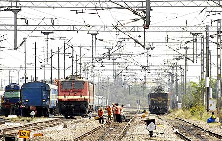 Railway employees work on a railway track in Hyderabad