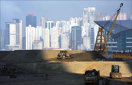 Bulldozers work on reclaimed land in Hong Kong.