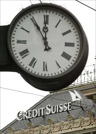 A clock seen atop the logo of Credit Suisse at the Paradeplatz square in Zurich.