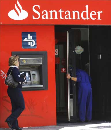 A man enters a Santander bank branch in Madrid.