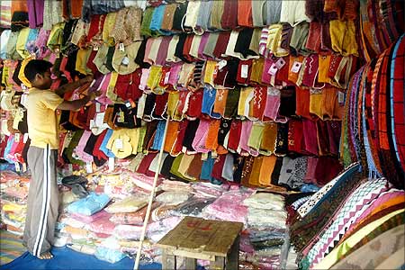 A vendor arranges woollen garments at a street market in Agartala, Tripura.