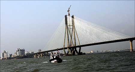 A boat sails past the Bandra-Worli sea link in Mumbai.