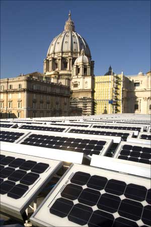 Solar panels cover the roof of the Paul VI hall near the cupola of Saint Peter's Basilica at the Vatican.
