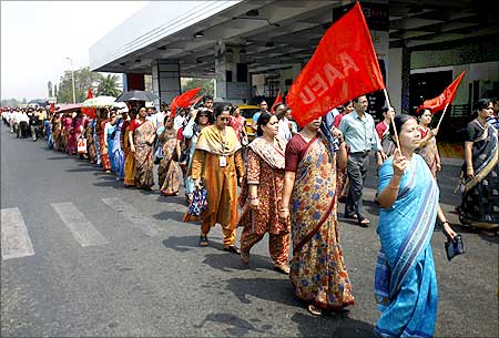 Employees of the Airports Authority of India march outside the airport during a protest in Kolkata.