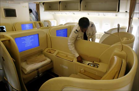An official looks at the newly introduced first class cabin section in Air India new Boeing 777-20.