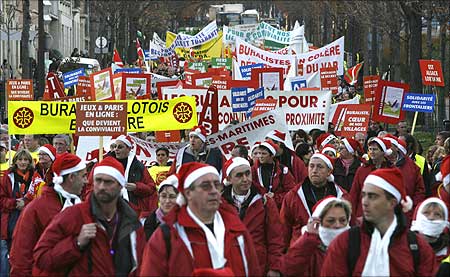 French tobacconists, wearing Santa Claus costumes, demonstrate to protest against a smoking ban.