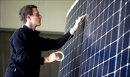 A team member works on the photovoltaic cells.