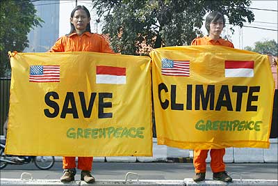 Greenpeace activists hold a banner urging world leaders to save the climate.