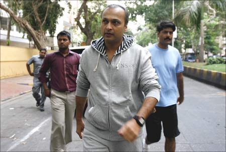 Anil Ambani, chairman of Anil Dhirubhai Ambani Group, surrounded by bodyguards, going to cast his vote at a polling centre in Mumbai on April 30.