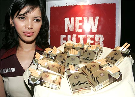 A saleswoman stands next to the Marlboro Mix 9 kreteks during its launch in Jakarta.