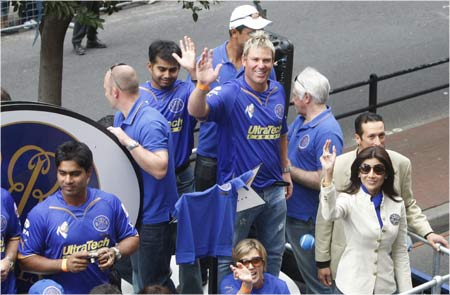 Members of the Rajasthan Royals cricket team wave to crowds during a street parade in Cape Town by teams competing in the Indian Premier League T20 cricket tournament.