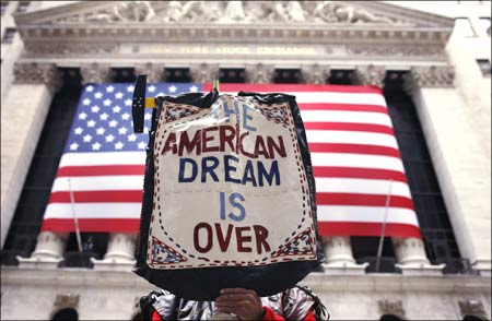 A demonstrator holds a sign reading The American dream is over during a rally outside Wall Street in New York.
