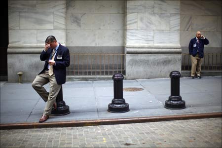 Traders stand outside the New York Stock Exchange even as the US goes through major economic turmoil.