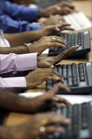 Employees at work in a firm in Mumbai.