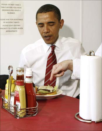 US President Barack Obama receives his lunch at Ray's Hell Burger in Arlington, Virginia.
