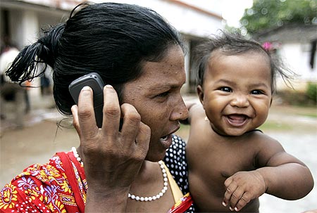 A Christian woman speaks on a mobile phone at a refugee camp in Bhubaneswar, Orissa.