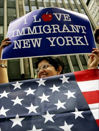A woman holds an American flag during the naturalisation ceremony for new citizens in New York.