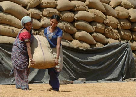 Labourers work inside a rice mill on the outskirts of Agartala.