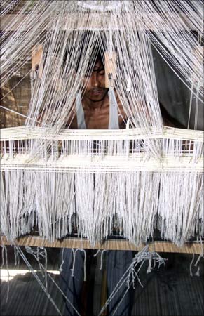 Nandu Chowdhry works on a handloom to make a silk cloth in the village of Sualkuchi in Assam.