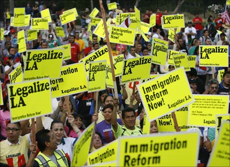 People take part in a May Day rally protest march for immigrant rights.