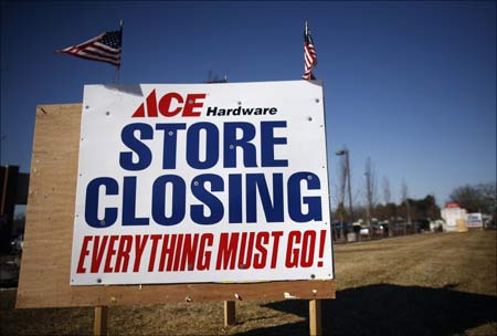 Signs advertising a store closing in Islip, New York.