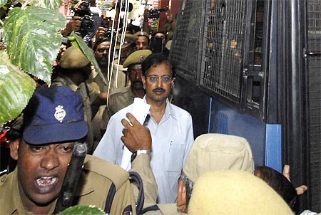 Ramalinga Raju, founder and former chairman of fraud-hit Satyam Computers, is escorted from a court in Hyderabad on April 9, 2009.
