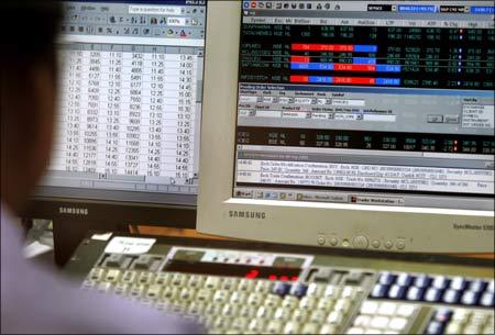 An Indian broker monitors stock prices during trading hours at a brokerage firm in Mumbai.